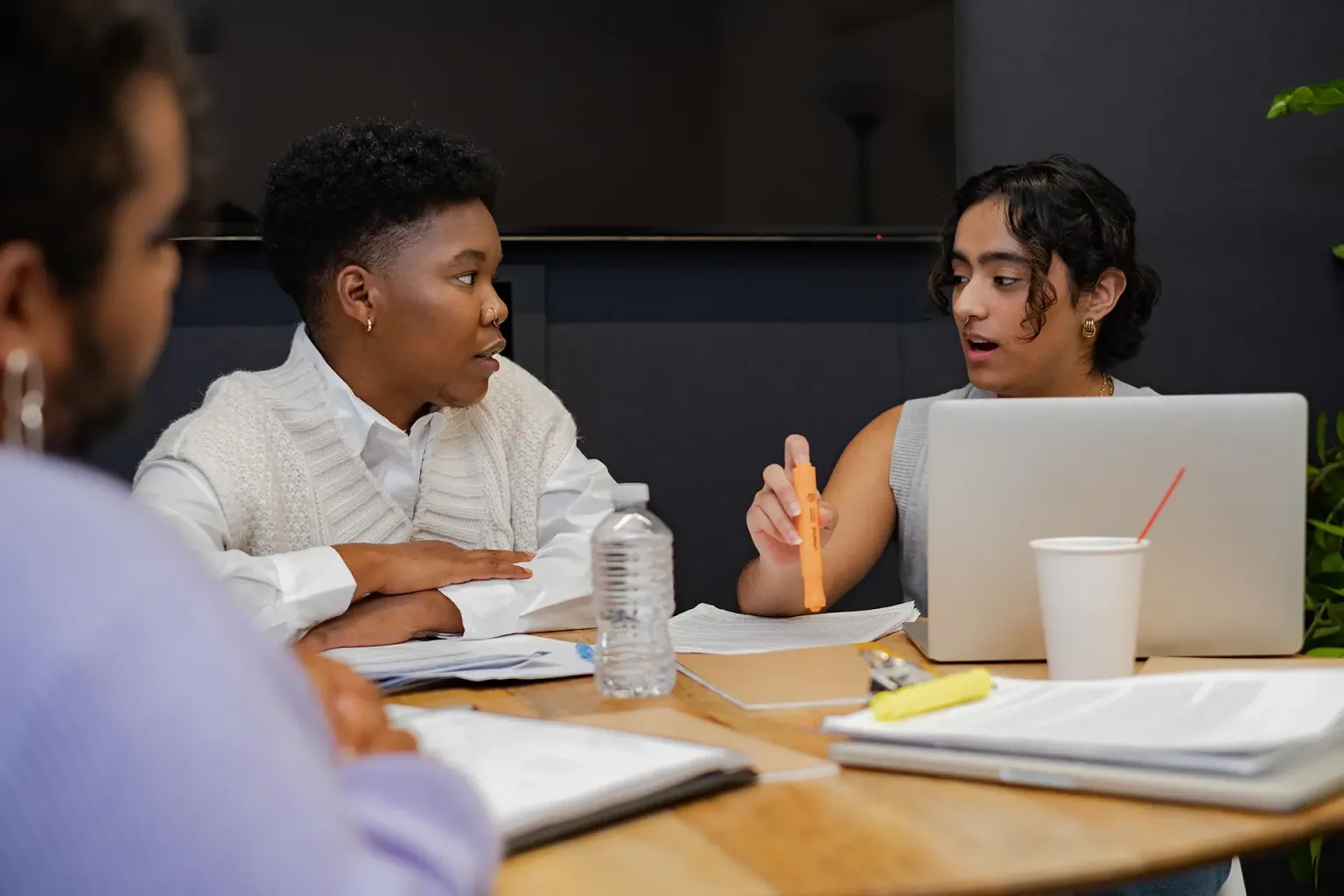 A group of individuals discussing something in a meeting